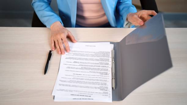 istock Caucasian woman sitting at her desk and reading important documents 1436114873