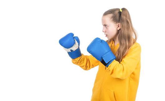 serious kid boxer in boxing gloves ready to fight and punch isolated on white, self-defense.