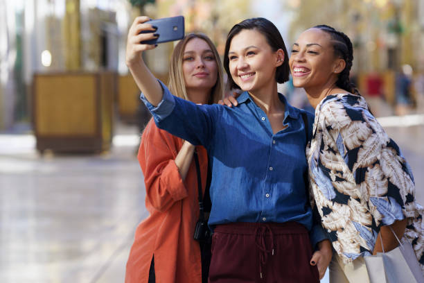 istock Joyful multiethnic women taking selfie on smartphone 1436116440