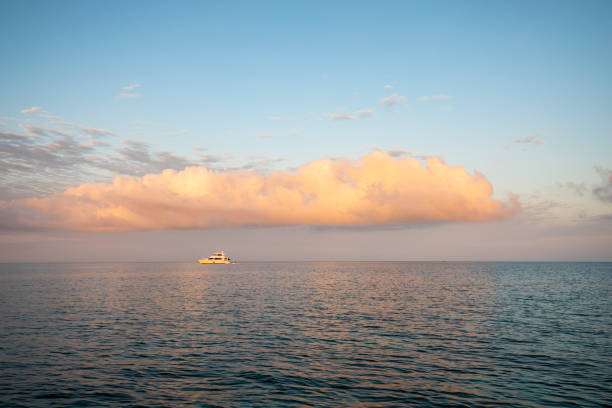 istock Boat moored in the calm tranquil ocean at sunrise 1436118276