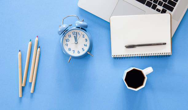istock Flat lay, alarm clock and stationery items on a blue background. 1436118361