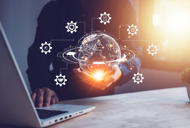 istock Hand of Businessman hold gear virtual global with hologram using notebook (Laptop). Metaverse and internet connection. Business technology link digital marketing. Big data and Financial banking. 1436120940