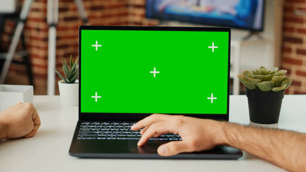 istock Young adult working on laptop with green screen template 1436121528