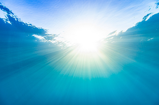 Underwater sun light rays in the deep blue ocean