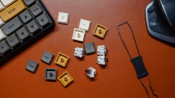 Top view of a mechanical keyboard with key caps on a brown leather background