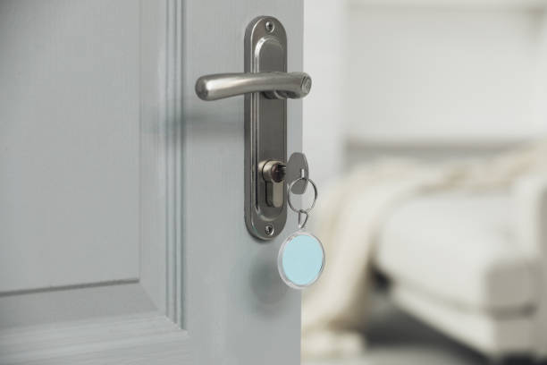 istock Closeup view of door with key open into room. Space for text 1436123724