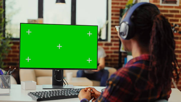 istock Female student with headset looking at greenscreen display 1436125328