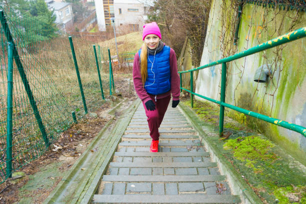 Outdoor sport exercises, sporty outfit ideas. Woman wearing warm sportswear training exercising outside during autumn.