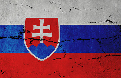 Slovakian Flag on cracked wall background.