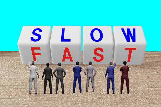 istock Businessman looking at SLOW and FAST character blocks 1436127537