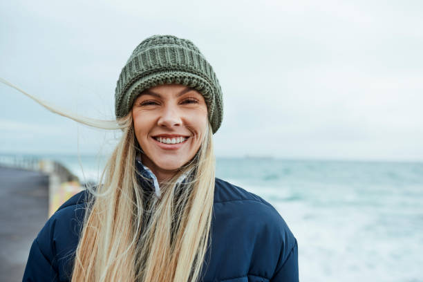 mulher, inverno ou liberdade por praia, oceano ou mar no canadá com metas voluntárias de mudança climática, meta de sustentabilidade ou mentalidade ambiental. retrato, sorriso feliz ou biólogo marinho por ondas da natureza - real people young women women beautiful - fotografias e filmes do acervo