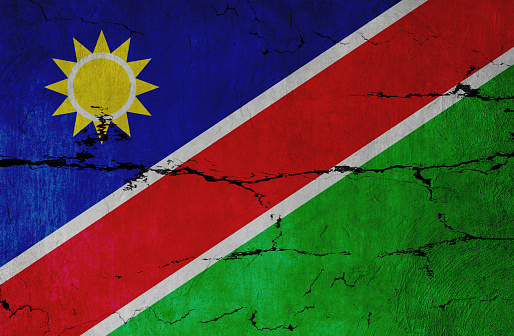 Namibian Flag on cracked wall background.