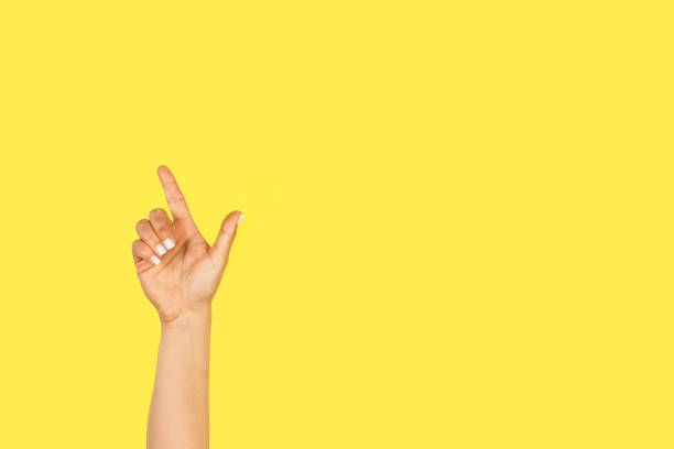 istock Woman hand doing celebration gesture on a yellow background 1436128364