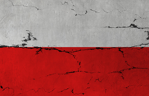 Polish Flag on cracked wall background.