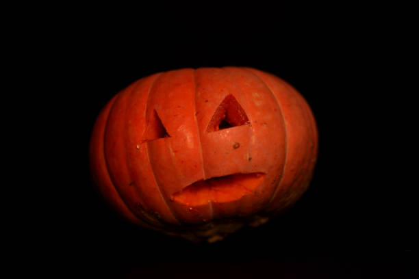 spooky concept - jack-o-lantern isolated on dark background. Halloween concept
