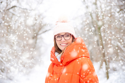 Portrait of a middle aged women standing outside on a snowy winter's day.