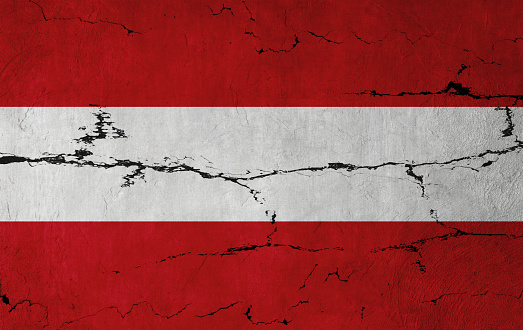 Austrian Flag on cracked wall background.
