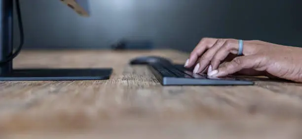 Typing on a desk in an modern office