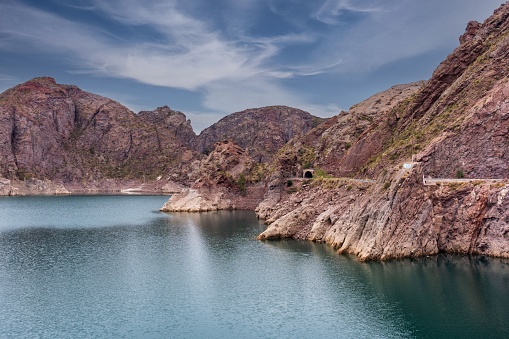 Lago cinematográfico rodeado de acantilados rojos en la Provincia de Mendoza, Argentina photo
