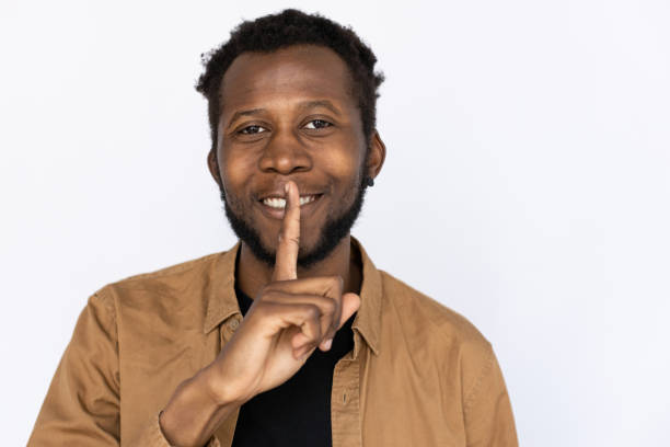 istock Joyful man showing hush sign 1436140250