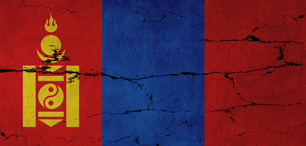 Mongolian Flag on cracked wall background.
