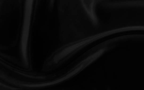 istock Black gray satin dark fabric texture luxurious shiny that is abstract silk cloth background with patterns soft waves blur beautiful. 1436140767
