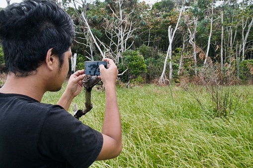 Youth filming and enjoying the outdoors on the west coast of Aceh, Indonesia