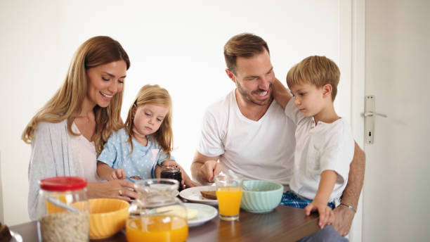 istock Parents with their kids in dining room having breakfast together 1436141886