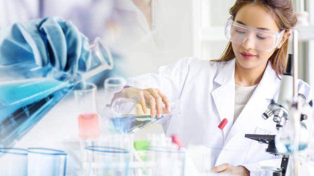 istock Attractive scientist woman testing chemical sample in flask at laboratory with lab glassware background. Science or chemistry research and development concept. 1436142610