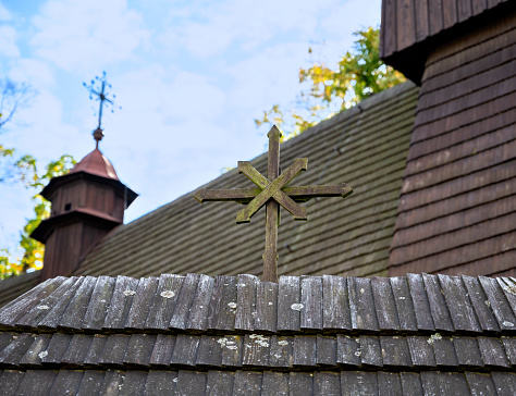 cross on the historic roman-catholic wooden church of the holy Francis of Assisi in the community Hervartov, Slovakia