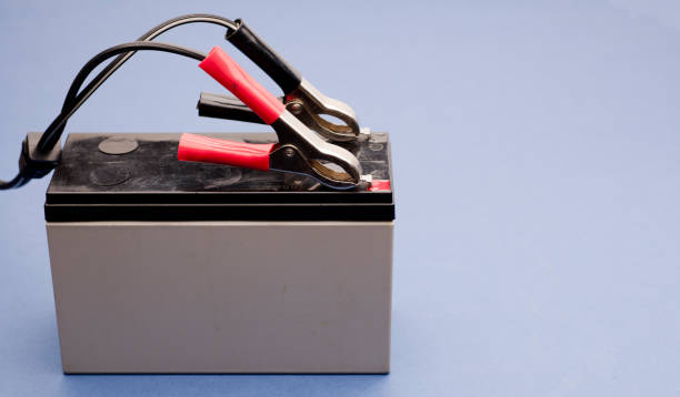 istock connected bolts charging battery positive pole and negative pole, blue background 1436144184