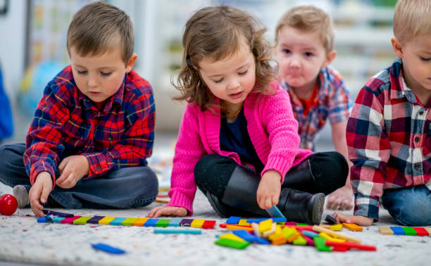 istock Little Girl Playing with Blocks 1436145361