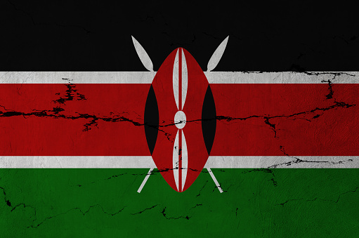 Kenyan Flag on cracked wall background.