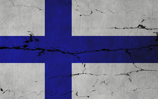 Finnish Flag on cracked wall background.