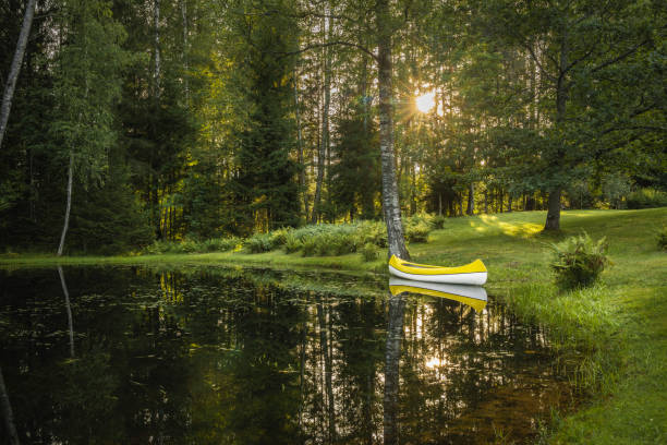 Boat on lake with a reflection in the water at sunset
