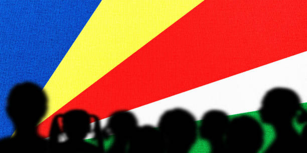 Small paper flag of Seychelles pinned. Isolated on white background. Horizontal orientation. Close up photography. Copy space.