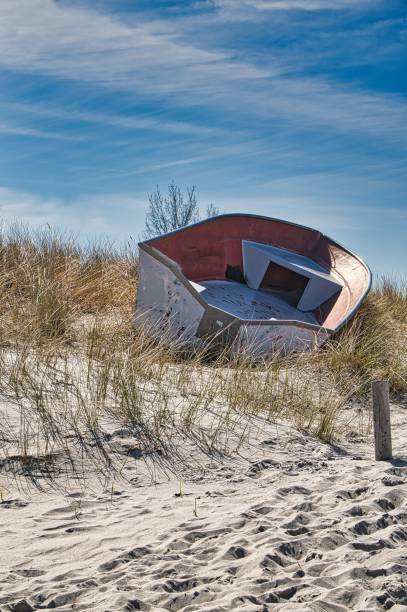 istock Vertical shot of an old empty boat on the sandy shore. 1436152351