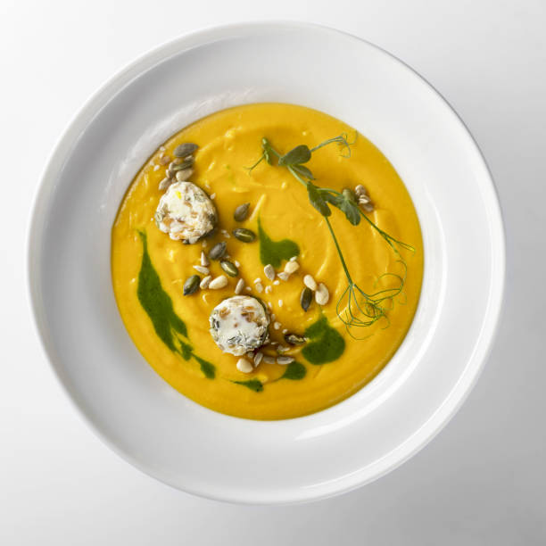 istock Pumpkin soup with pumpkin seeds on a white background 1436154454
