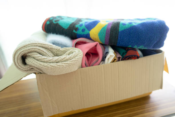 istock Donation box with used clothes at home to support help for poor people in the world. 1436155621