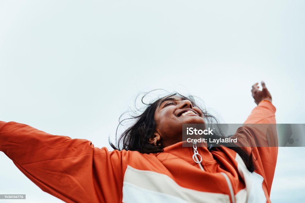 Happy black woman, freedom and sky for success in adventure, travel or achievement in the outdoors. Female winner celebrating goal being free in nature for successful traveling to India in happiness Happy black woman, freedom and sky for success in adventure, travel or achievement in the outdoors. Female celebrating goal being free in nature for successful traveling to India in joyful happiness Aspirations Stock Photo