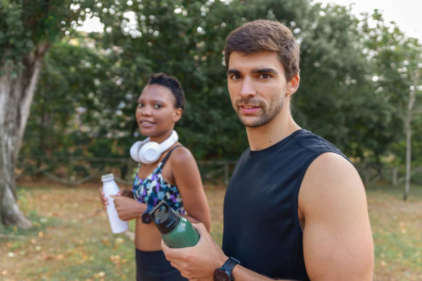 istock Sportive couple looking at camera in morning park 1436158237
