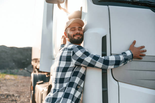 istock Embracing his vehicle. Young truck driver is outdoors at day time 1436158983
