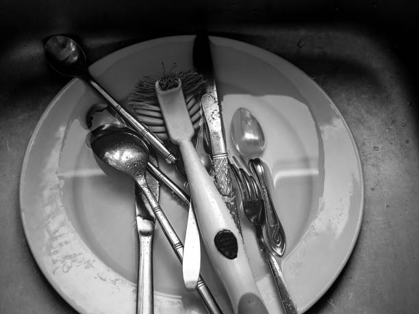 istock silver wear and white plate in sink being washed 1436159069