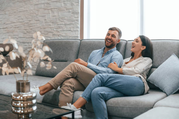 istock Sitting and testing product. Couple choosing the sofa and bed in the store 1436159976