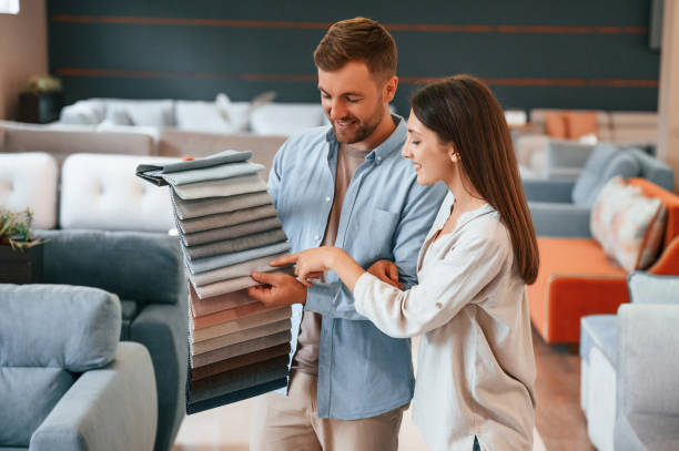 istock Having fun by choosing the sofa. Couple is in the store 1436160024