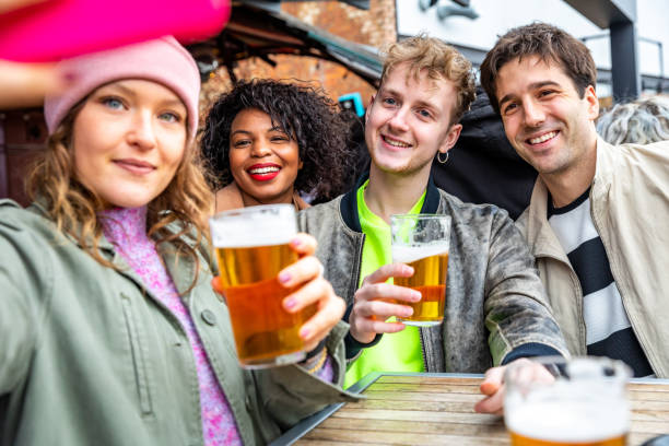 istock Friends drinking and toasting with beer at pub and taking a selfie 1436160070
