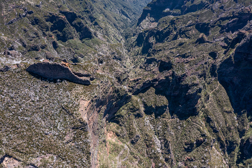 Aerial view of the valley among the Madeira mountains on a sunny day.