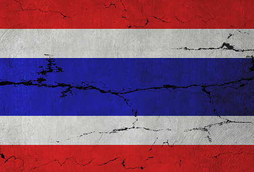 Thai Flag on cracked wall background.