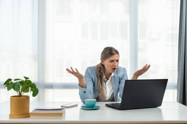 istock Young frustrated business woman office worker trying to concentrate for her work while she sitting in the company office with old laptop computer and slow internet connection. 1436161840
