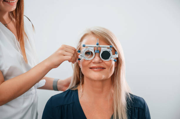 istock Wearing glasses. Woman's vision is tested by clinic worker that using special device 1436162872